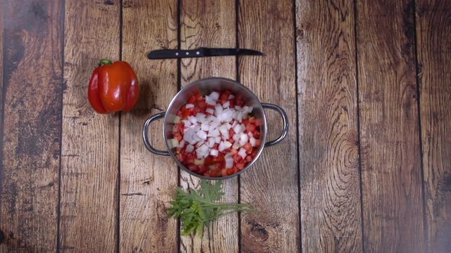Cooking red soup. Quick recipe.Top view on food ingredients. Stop motion animation flick of a woman’s fingers. The whole process
