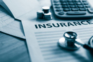Health insurance form with money,passbook ,calculator and stethoscope concept for life planning