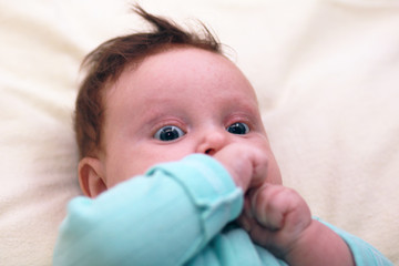 Face of the baby of the girl closeup. Cute newborn baby girl.