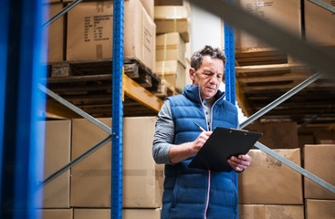 Portrait of a senior male warehouse worker or a supervisor.
