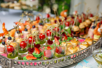 Light snacks, canap s with lard, cheese, meat, sauce, cherry tomatoes. Snacks for parties.