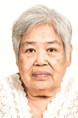 Serious looking senior woman portrait. Dramatic look. Old chinese woman.