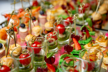Light snacks, canap s with lard, cheese, meat, sauce, cherry tomatoes. Snacks for parties.