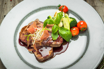 Medallions of veal, with sauce on a plate.