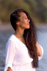 Beautiful Asian model from Tibet posing at sunset for portrait photography