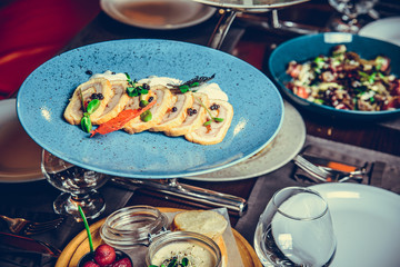 many different dishes in Restaurant, white plate on the Table with side dish,