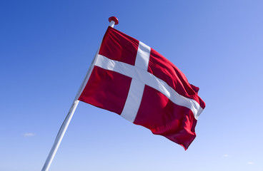 Seafaring / Flags / Denmark: The Danish national flag Dannebrog at the stern of a RoRo vessel is fluttering in the wind
