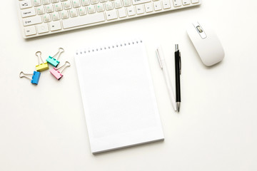 white Desk, notebook, pen, keyboard and mouse, white background with copy space, for advertisement, top view