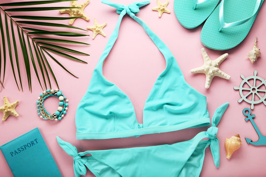 Blue swimsuit with palm leaf and starfishes on pink background