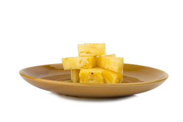Pineapple piece on dish isolated on white background