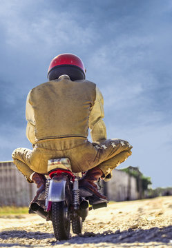 man riding mini motorcycle