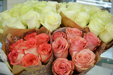 Beautiful bouquets of roses are presented in street flower shop