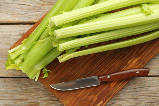 Celery on cutting board with knife