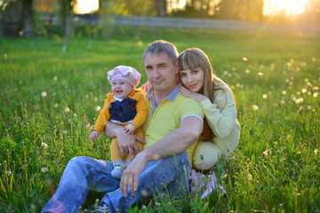 Naklejka na ściany i meble young family in the summer field