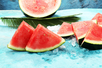 watermelon on blue background. juicy summer fruit in slices