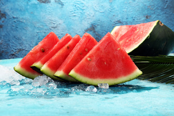 watermelon on blue background. juicy summer fruit in slices