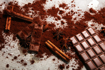 Chocolate bars on table with chocolate powder.