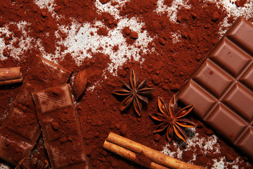 Chocolate bars on table with chocolate powder.