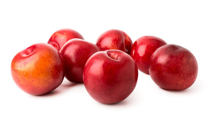 Fototapeta na wymiar Ripe plums scattered on a white background