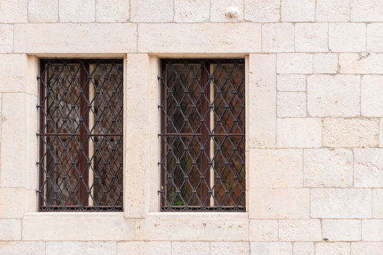 two window with a medieval-style grille in the castle