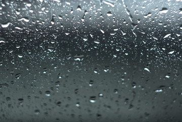 Water drops on glass. The window In rainy weather. Closeup. 