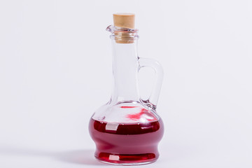 Glass vessel with red liquid. Laboratory flask.
