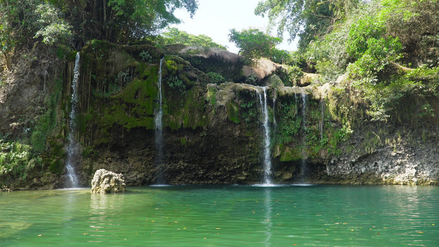 Fototapeta Waterfall in green rainforest. Bolinao waterfall in the mountain jungle. Philippines, Luzon. Travel concept.