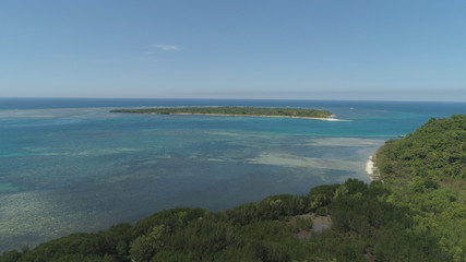Tropical island with white sandy beach. Aerial view: Magalawa island with colorful reef. Seascape, ocean and beautiful beach paradise. Philippines,Luzon. Travel concept.