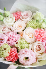 flower arrangement. multicolor bouquet of beautiful flowers on wooden table. Floristry concept. Spring colors. Vertical photo