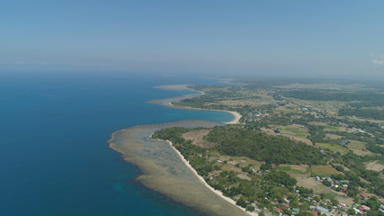 Fototapeta na wymiar Aerial view of seashore with beaches, lagoons and coral reefs. Philippines, Luzon. Coast ocean with turquoise water. Tropical landscape in Asia.