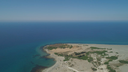 Aerial view of seashore with beaches, lagoons and coral reefs. Philippines, Luzon, Ilocos Norte. Coast ocean with turquoise water. Tropical landscape in Asia.
