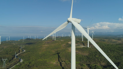 Aerial view of Windmills for electric power production on the seashore. Bangui Windmills in Ilocos Norte, Philippines. Ecological landscape: Windmills, sea, mountains. Pagudpud