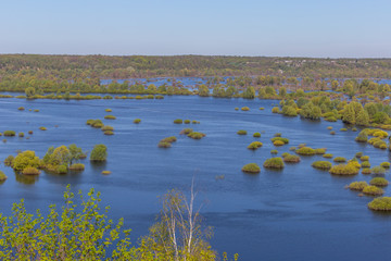Aerial landscape view on Desna river with flooded meadows and beautiful fields. View from high bank on annual spring overflow . Novgorod-Siversky, Ukraine.