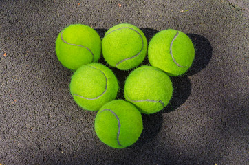 Tennis balls lying on the field.