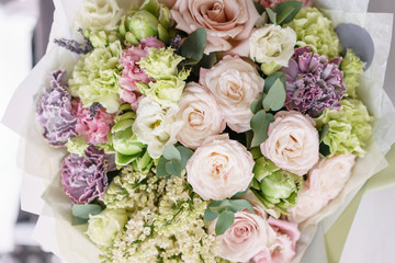 flower arrangement. multicolor bouquet of beautiful flowers on wooden table. Floristry concept. Spring colors. Vertical photo
