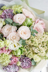 flower arrangement. multicolor bouquet of beautiful flowers on wooden table. Floristry concept. Spring colors. Vertical photo