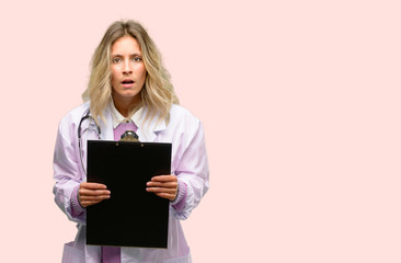 Fototapeta premium Young doctor woman, medical professional scared in shock, expressing panic and fear