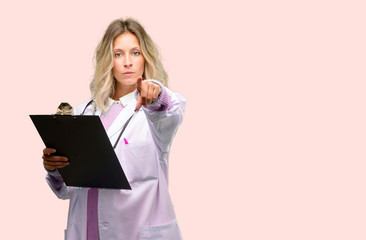 Young doctor woman, medical professional pointing to the front with finger