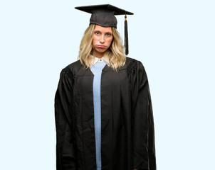Young graduate woman with sleepy expression, being overworked and tired