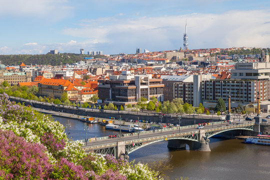 PRAGUE, CZECH REPUBLIC - APRIL, 30, 2017: Spring city panoramic view from Letenske garedn. Old and modern buildings and bridges over Vltava river.