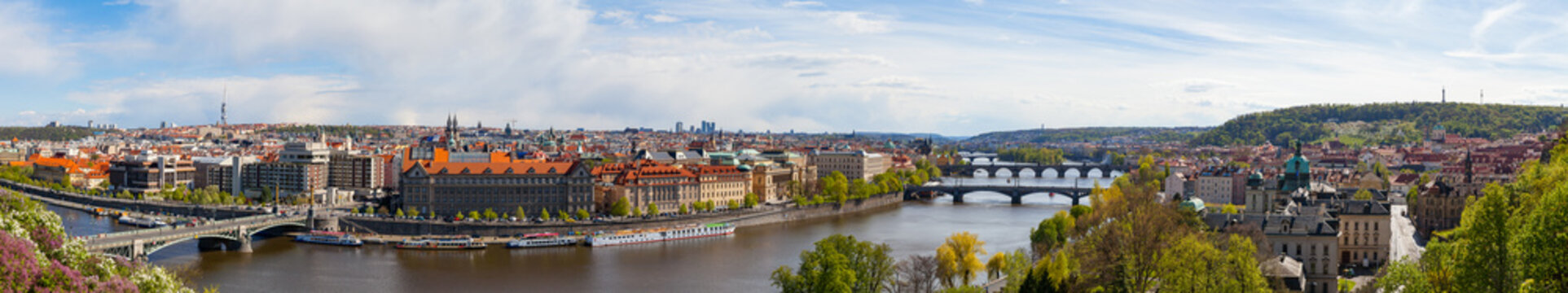 PRAGUE, CZECH REPUBLIC - APRIL, 30, 2017: Spring city ultra wide panoramic view from Letenske garedn. Old and modern buildings and bridges over Vltava river.