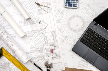 drawing engineering tool bearings laptop on the table