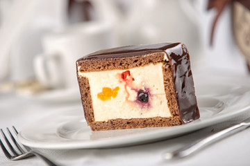 cakes on a white plate, restaurant setting.