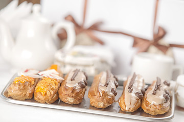 Tasty cakes on a tray, restaurant setting.