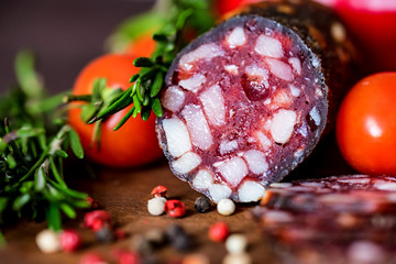 Tasty salami with tomatoes and peppercorn close