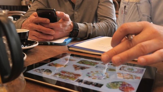 Close-up of a Hand use a Digital Tablet, browsing Photos of Food in Google