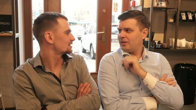 Two Business Men planning work with Pen and Paper on a Lunch in Cafe
