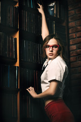 Fototapeta premium schoolgirl in old library