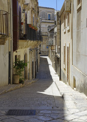 A street in the Sicilian baroque town of Scicli in southern Sicily, Italy