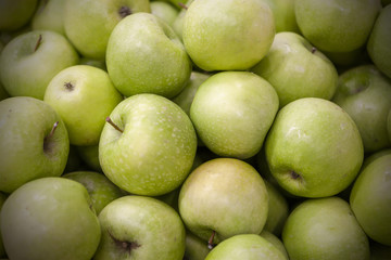 Fresh apples spread out an even layer as a background.